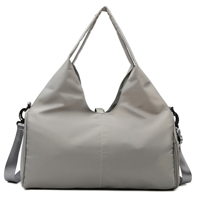 Women's gym travel bag lifestyle image with multiple storage compartments